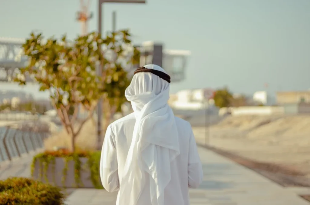 person-in-white-robe-standing-on-road-during-daytime