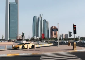 yellow-car-on-road-near-building-during-daytime